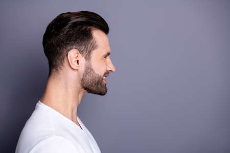 Close up side profile photo amazing he him his wondered funny macho perfect ideal appearance easy-going reliable person reveal teeth laughter wear casual white t-shirt isolated grey backgroundの写真素材