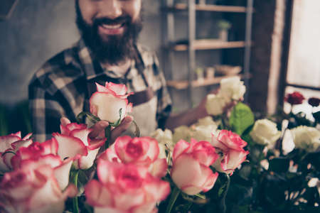 Cropped close up photo nice attractive cheerful guy touch plant assortment variety rose surprise birthday anniversary 8-match enjoy satisfied adorable nature botanical garden plaid youth shirtの写真素材