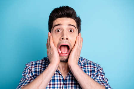 Close up photo disappointed confused youngster touch hands palms face cheek shout bristle impressed heard horrible news information horror secret gossip rumor plaid outfit isolated pastel backgroundの写真素材