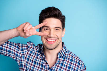 Close up photo of cute nice pretty man have free time weekend relax holidays make v-sign put ear face eyes stubble dressed modern spring clothing isolated on pastel backgroundの写真素材