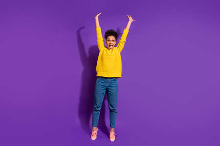 Full length body size view portrait of her she nice attractive cheerful cheery excited optimistic wavy-haired girl having fun time rising hands up isolated over bright vivid shine violet backgroundの写真素材