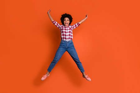 Full body photo of excited crazy jumping high lady yelling yeah raise hands wear jeans denim pants...