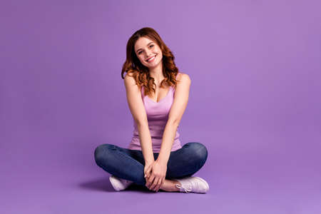 Portrait of pretty millennial feel glad lovely sit wear singlet tank-top modern, fashionable isolated colorful purple violet backgroundの写真素材