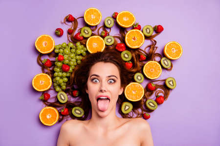 Close-up portrait of her she nice cute attractive lovely well-groomed cheerful cheery girlish crazy comic playful wavy-haired lady having fun fooling isolated over violet purple backgroundの写真素材