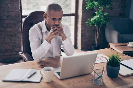 Portrait of his he nice busy focused concentrated guy chairman ceo boss chief researching reading finance sales plan strategy buyer assistant at industrial loft interior work place stationの写真素材