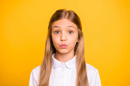 Close-up portrait of her she nice-looking attractive winsome sweet well-groomed pretty cheerful funny straight-haired pre-teen girl pout lips isolated over bright vivid shine yellow backgroundの写真素材