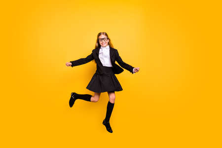 Full size photo of cute kid jumping have eyewear eyeglasses isolated over yellow background