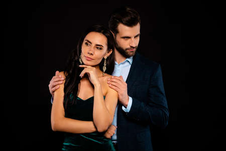 Close up photo rich pair classy she her chic hand arm fingers chin he him his hold shoulders look side piggyback pose wear blue plaid costume jacket velvet green dress isolated black backgroundの写真素材