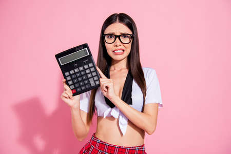 Photo of pretty lady hold calculator spend salary have no money for living wear white top short skirt isolated pink backgroundの写真素材