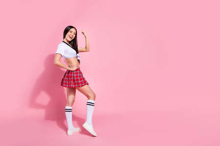 Full length body size profile side view of her she nice-looking attractive graceful sporty slender cheerful cheery glad straight-haired lady satisfaction isolated on pink pastel backgroundの写真素材