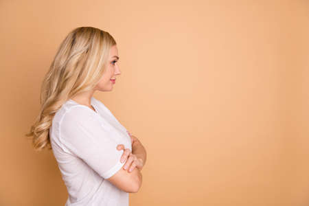 Profile side view portrait of her she nice-looking lovely winsome attractive groomed gorgeous lovable shine wavy-haired lady isolated over beige pastel backgroundの写真素材