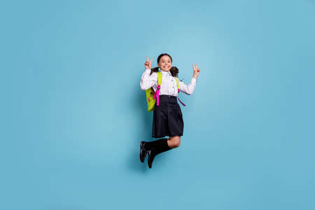 Full body size photo of crazy school lady rushing classroom see friends v-sign symbol wear white shirt isolated blue backgroundの写真素材