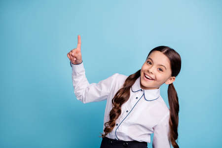 Close up photo of cute kid choose decide choice decision wear white blouse skirt isolated over blue backgroundの写真素材