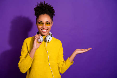 Portrait of pretty lady hold hand have party event eyewear eyeglasses earphones isolated on purple violet backgroundの写真素材