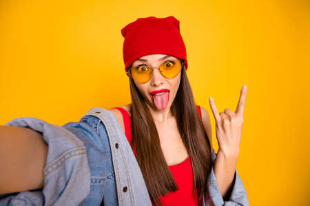 Close up photo of funny beautiful student pank have party wear stylish trendy eyewear eyeglasses make photos isolated over yellow backgroundの写真素材
