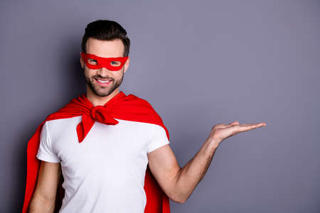Portrait of his he nice-looking attractive content virile macho cheerful cheery bearded guy holding copy space on palm advert ad solution alternative option isolated over gray pastel backgroundの写真素材