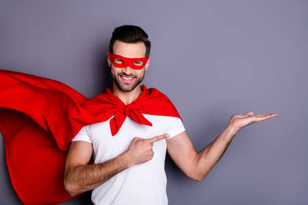 Portrait of his he nice-looking attractive content macho cheerful cheery bearded guy holding copy space on palm advert best solution choose choice isolated over gray pastel backgroundの写真素材