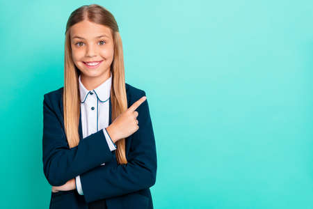 Close up photo beautiful she her little lady pretty hairdo like love study school hand arm index finger empty space wear formalwear shirt blazer school form isolated bright teal turquoise backgroundの写真素材
