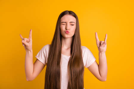 Portrait of nice girl with lips pouted on  isolated yellow backgroundの写真素材
