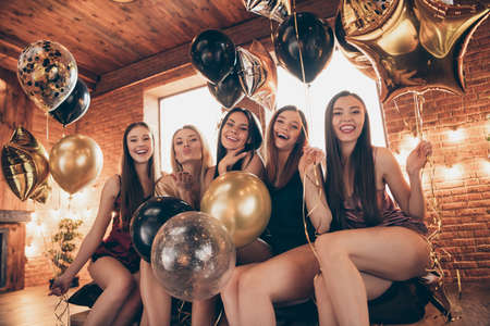 Close up photo beautiful flirty five she her buddies fellows fancy chic ladies bachelor send air kisses laugh bed linen sheets decorated glossy room friendly sleep costumes day night house indoorsの写真素材