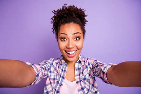 Close up photo of funny cute lady enjoy satisfied candid rejoice make photos summer travel trip have free time holidays weekends wear plaid modern fashionable outfit isolated on purple backgroundの写真素材