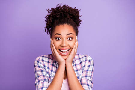 Close-up portrait of her she nice charming cute attractive winsome cheerful cheery wavy-haired girl wearing checked shirt showing amazement isolated over violet purple pastel backgroundの写真素材