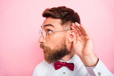 Close-up photo of funny funky smart concentrated hipster gentleman holding palm near ear catching...