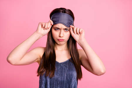 Close-up portrait of her she nice-looking attractive lovely winsome shine moody waken up straight-haired teenage girl putting on blindfold isolated over pink pastel backgroundの写真素材