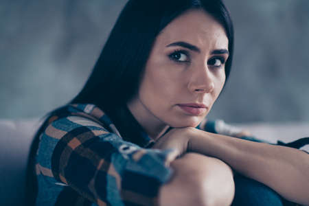 Close up side profile photo beautiful she her lady arm hold head on knees displeased hopeless suffering break up husband boyfriend wear checkered plaid shirt comfort flat house living room indoorsの写真素材