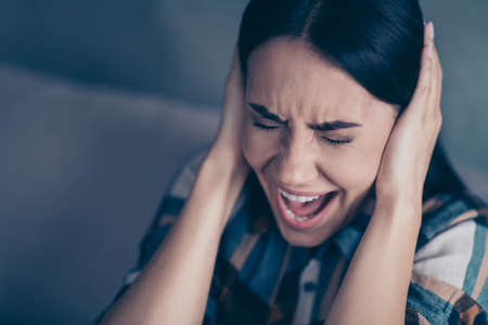 Close up photo beautiful she her lady arm hold hide ears eyes closed terrible suffer pain displeased yelling loud ask please stop wear checkered plaid shirt comfort flat house living room indoorsの写真素材