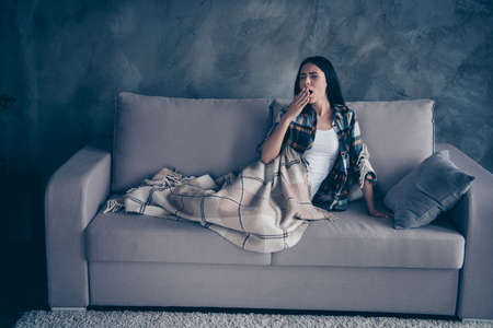 Close up photo beautiful she her lady fell asleep dreaming covered blanket just woke up eyes closed yawn hand arm wear checkered plaid shirt lying comfy divan flat house living room indoorsの写真素材