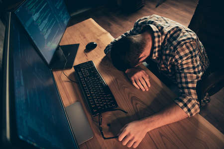Top above high angle view of his he nice guy sleeping in front of monitor genius specialist hard-working at wooden industrial interior work place station indoorsの写真素材