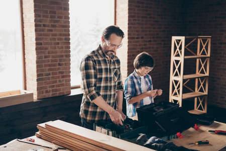 Portrait of serious profs occupation creative skilled dad son kid concentrated workstation hobby fix...