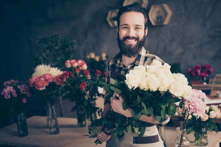 Close up photo charming lovely sweet man hold hand assortment small business representative content surprise anniversary fest enjoy natural floral wear plaid modern youth clothing wall orangeryの写真素材