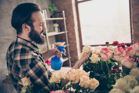 Profile side view photo of charming stylish trendy nice pretty youth vendor assistant hold hand rosebud environment botanical wear checked shirt outfit glasshouseの写真素材