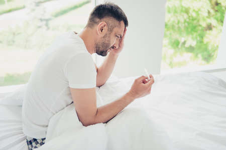 Close up side profile photo amazing he him his unhappy guy hold thermometer terrible hurt pain...