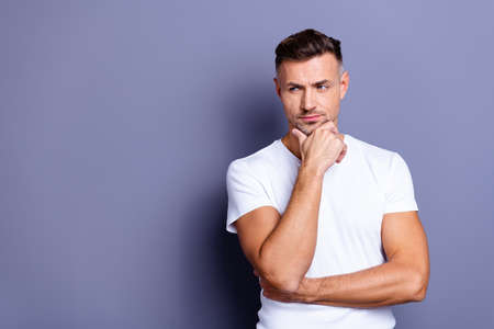 Close up photo amazing he him his middle age macho perfect appearance hands arms chin, look side empty space pensive ponder doubtful unsure uncertain wear casual white t-shirt isolated grey backgroundの写真素材