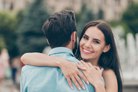 Close up photo of positive cheerful content couple married people youth have free time stroll weekend toothy candid enjoy romance romantic blue shirt denim jeans long haircutの写真素材