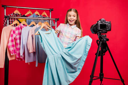 Portrait of her she nice-looking attractive lovely charming cheerful cheery confident girl recommending wear look outfit streaming online internet isolated over bright vivid shine red backgroundの写真素材