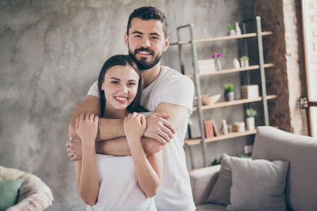 Portrait of two nice attractive lovely stylish cheerful cheery positive gentle confident people sending free time at industrial loft interior style room house apartmentの写真素材