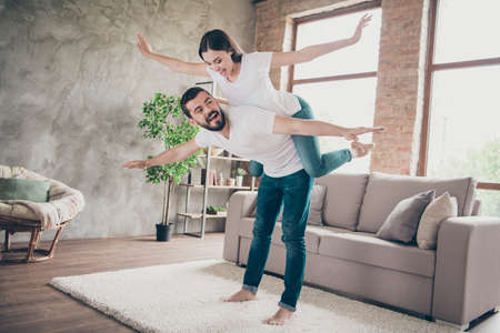 Full length body size view of his he her she two nice attractive lovely childish playful carefree cheerful cheery positive people having fun at home house apartment indoorsの写真素材