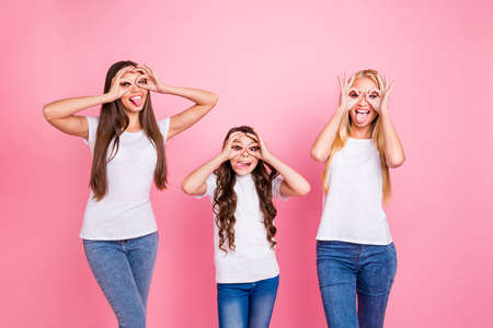 Portrait of three nice attractive lovely cheerful cheery crazy long haired girls relatives showing ok-sign enjoying holiday weekend having fun isolated over pink pastel backgroundの写真素材