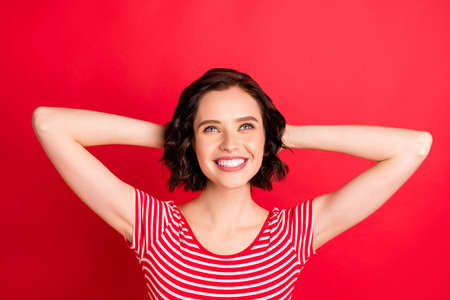 Close-up portrait of her she nice attractive pretty lovely cheerful cheery wavy-haired teen girl having rest time looking up dreaming isolated over bright vivid shine red backgroundの写真素材