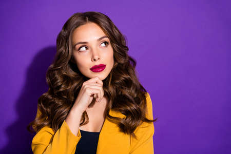 Photo of pensive pondering attractive woman planning development of her company isolated with purple backgroundの写真素材