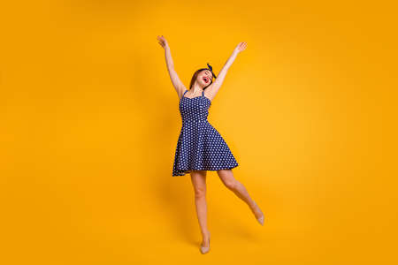 Full length photo of cute youth raise hands arms close eyes isolated over yellow background