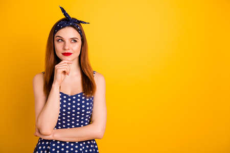Photo of amazing foxy lady red pomade hand chin ponder wear casual dotted dress headband isolated vivid yellow backgroundの写真素材