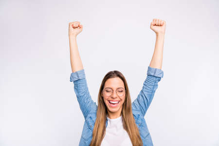 Photo of optimistic believing in good lady raising hands up isolated grey background
