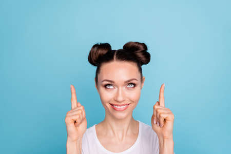 Funny lady indicating fingers up empty space advising low prices wear white casual t-shirt isolated...