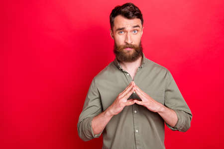 Photo of thinking considering man trying to find out what he sees while isolated with red background