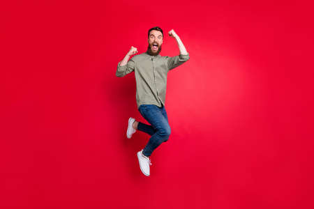 Full length body photo of crazy guy enjoying his promotion at work while isolated with red...